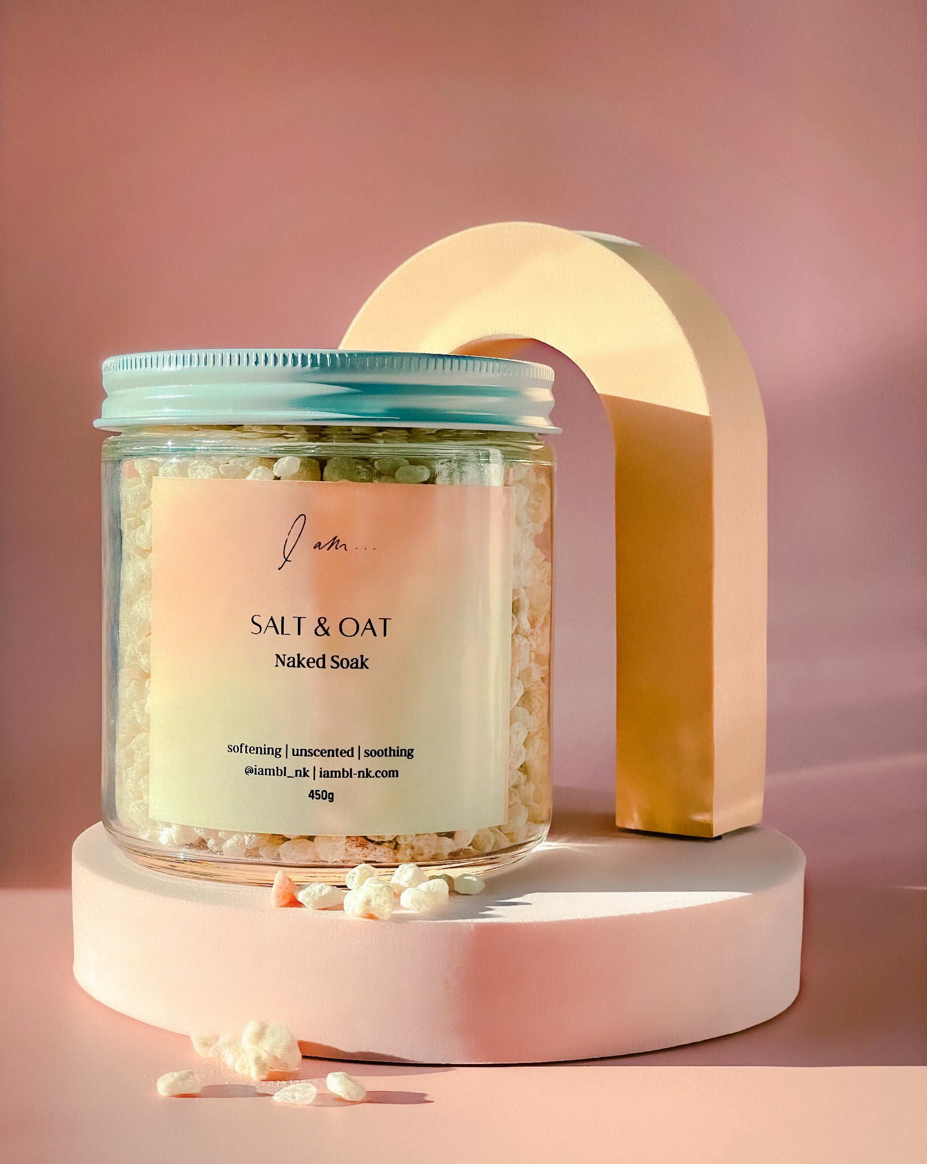 Me-Time Rose de mai soak, photo shows a jar flat lay with soak salts and colloidal oats pouring out of the jar